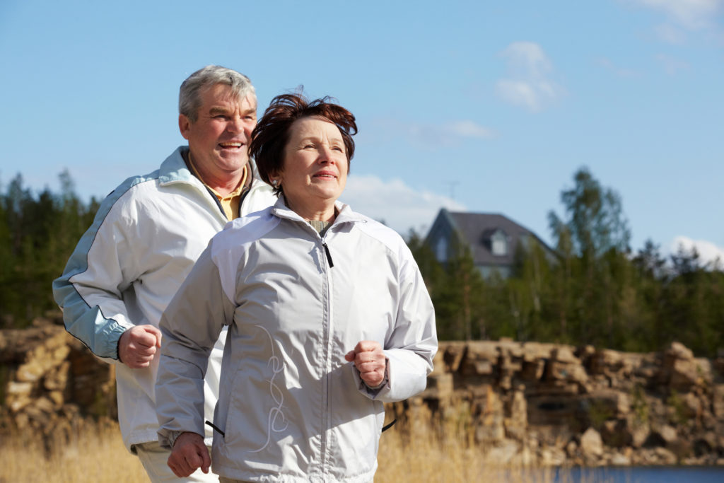 Portrait of happy mature couple running together